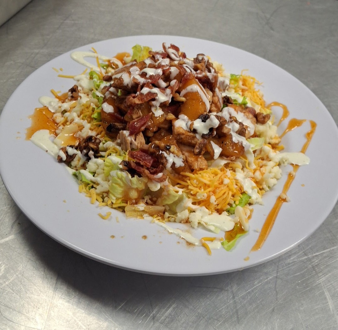 Cafe 51 Georgia Peach Salad with mixed greens, grilled chicken, peaches, cheese, bacon, and candied walnuts